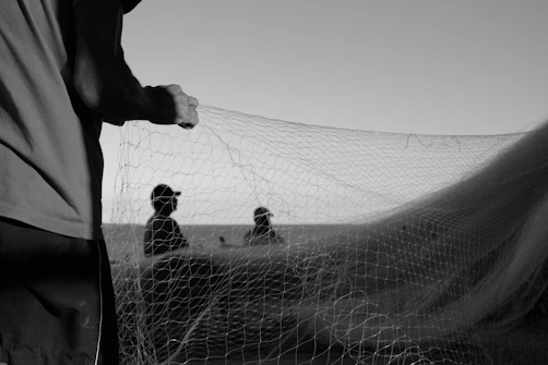 a group of people standing next to a net
