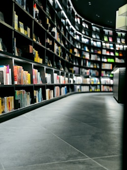 a row of books in a library filled with lots of books