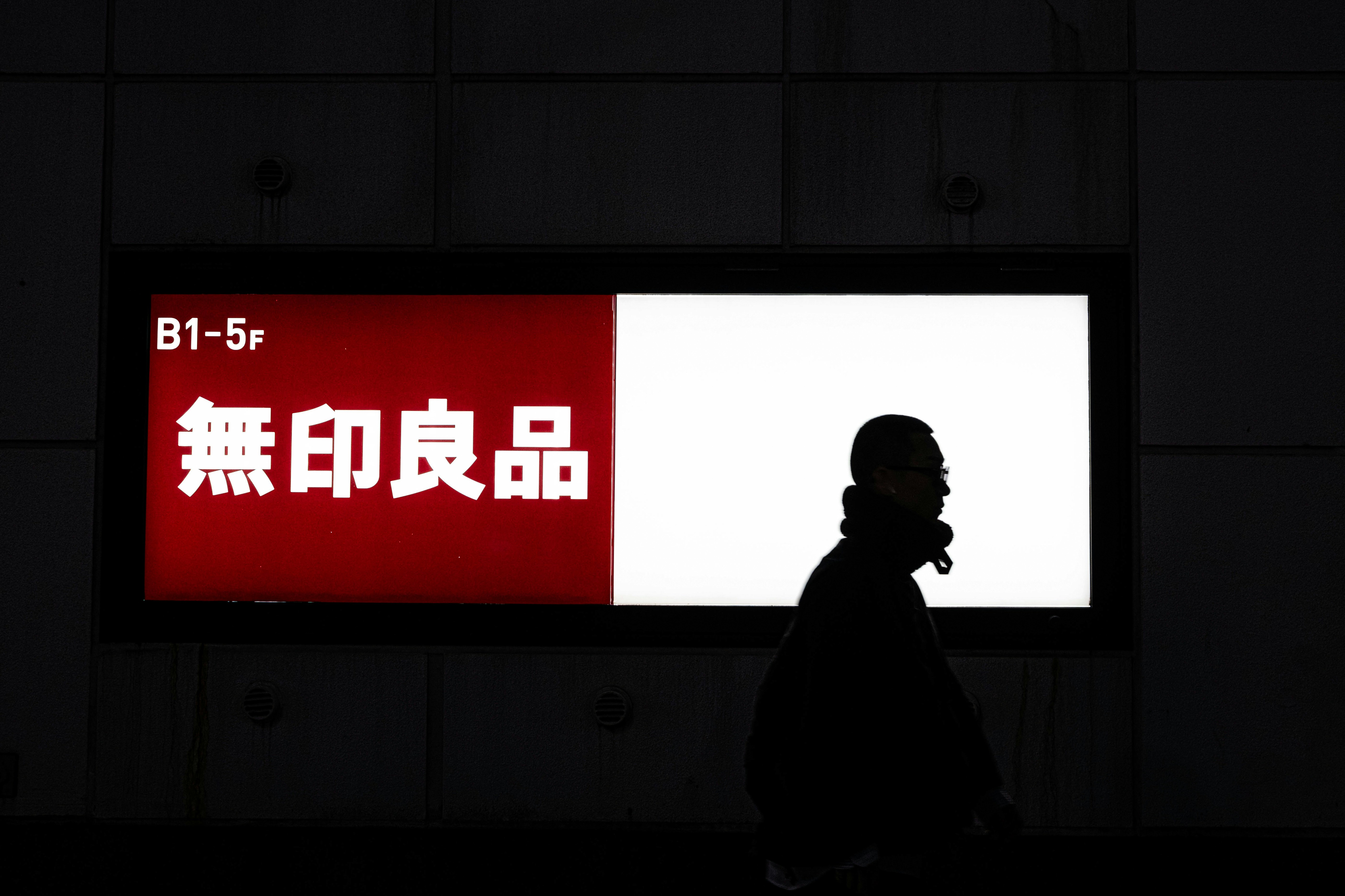 A person walking past a sign in a building photo – Free Travel Image on ...