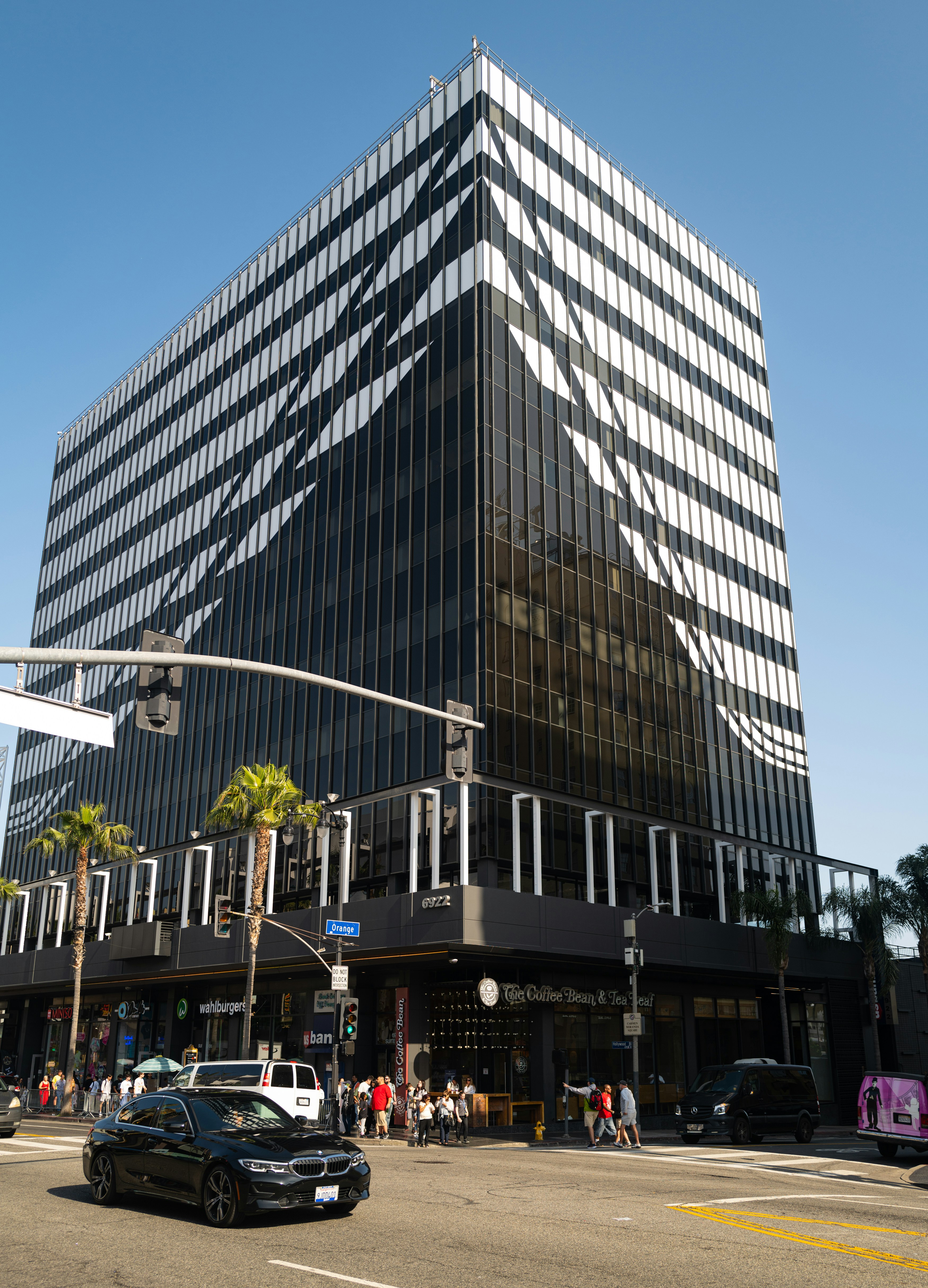 A very tall building sitting on the side of a road photo – Free ...