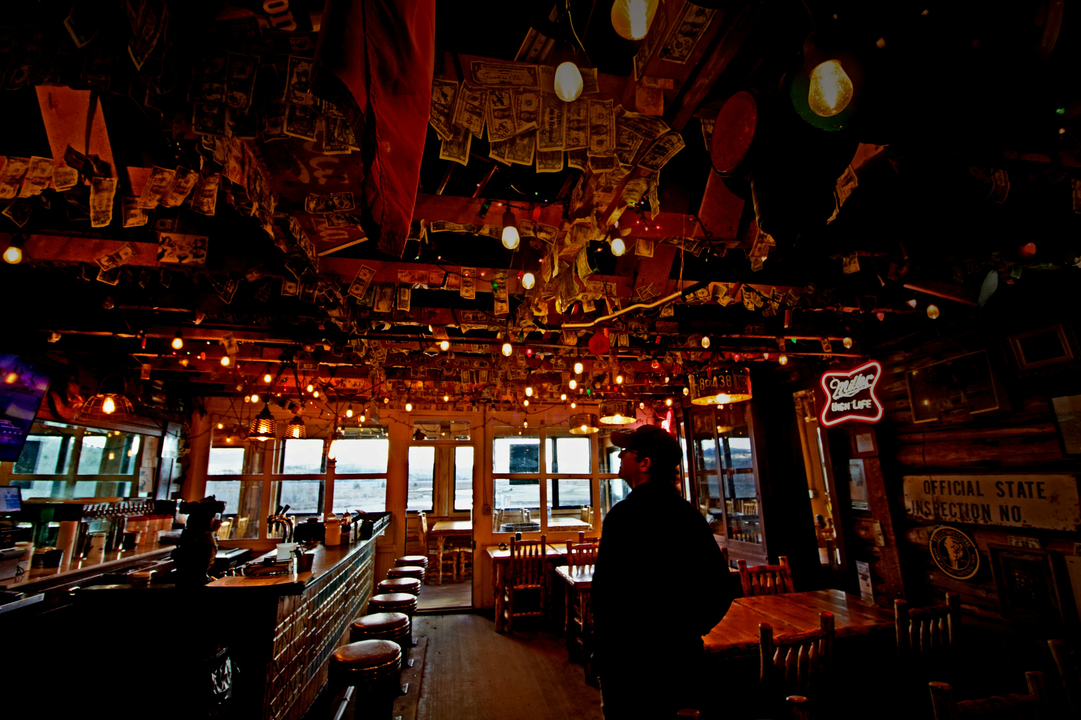 a person standing in a room with lots of lights, Todd looks around Buffalo Valley Ranch Cafe near Moran, Wyoming, in May, 2024.