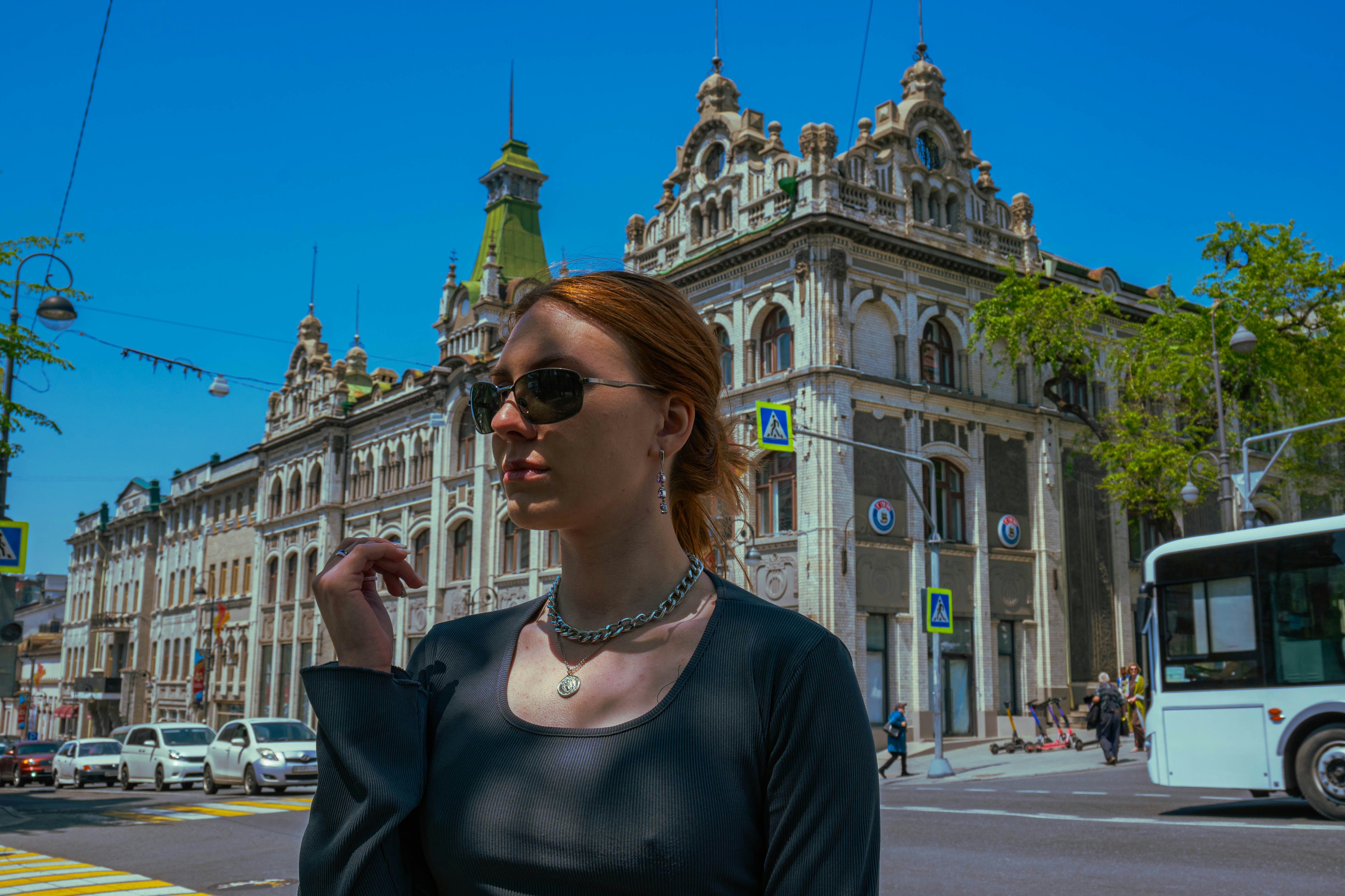 a woman standing in front of a large building