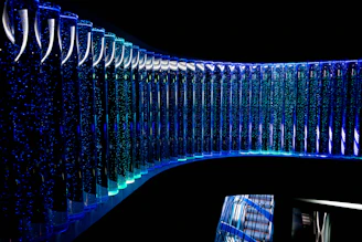 a curved glass wall in a dark room