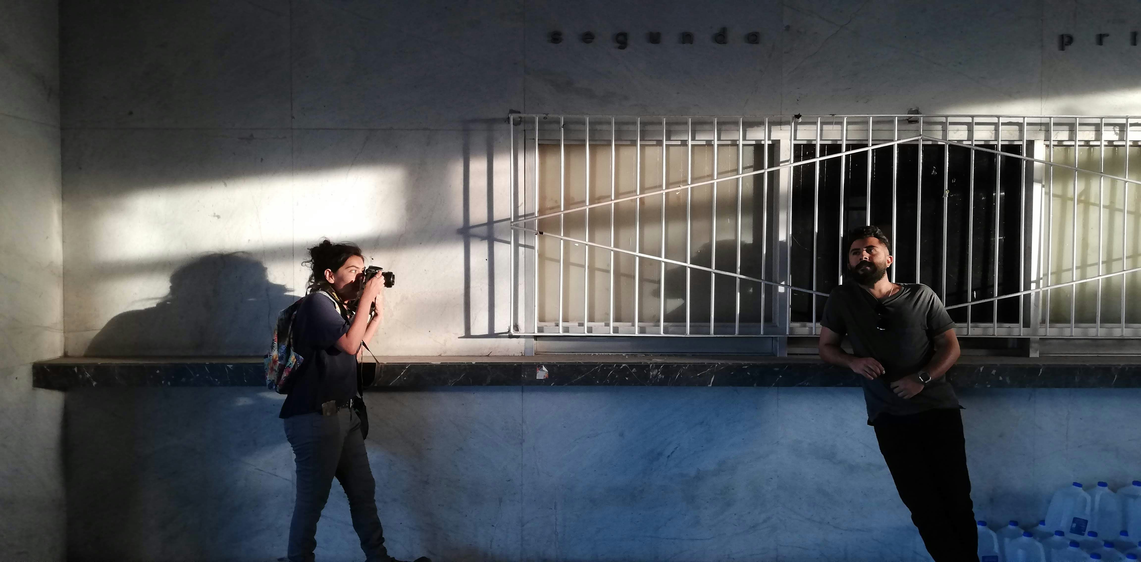 a man and a woman standing in front of a jail cell
