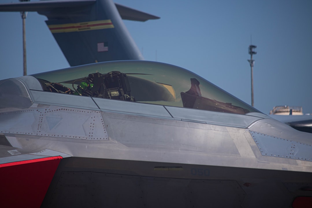 a fighter jet sitting on top of an airport tarmac,