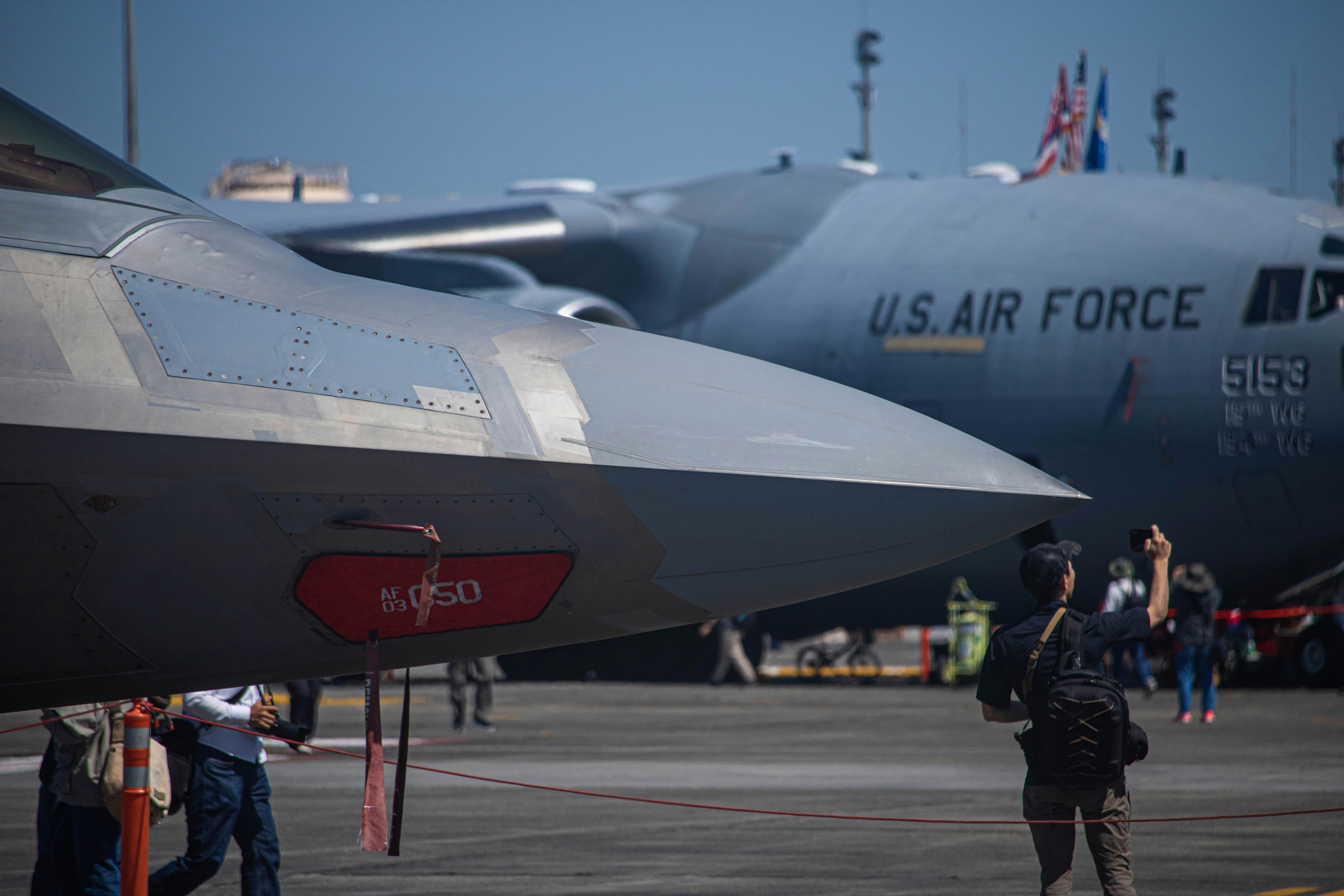 a large air force jet sitting on top of an airport tarmac, 