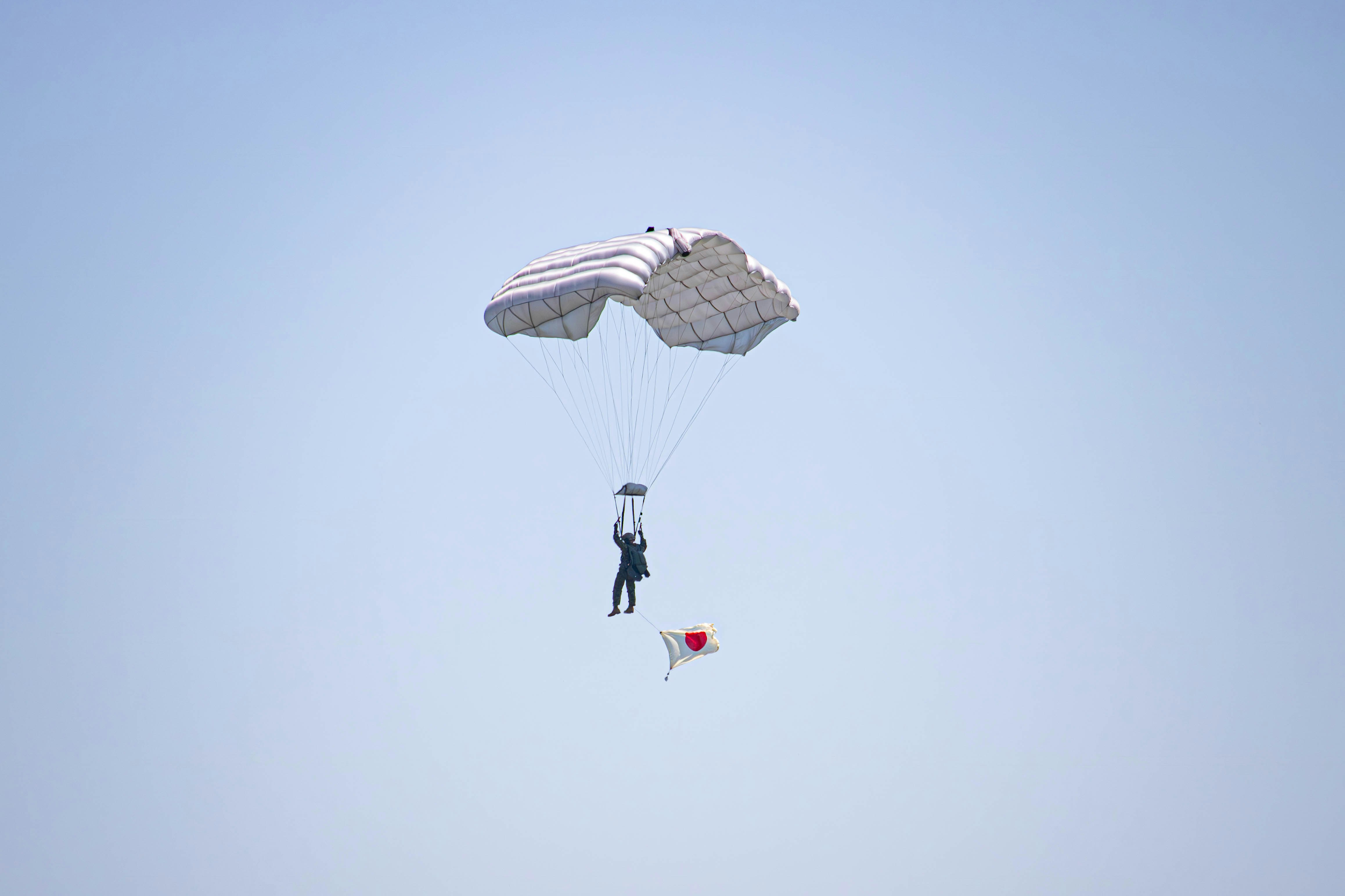 a person is parasailing in the sky with a parachute