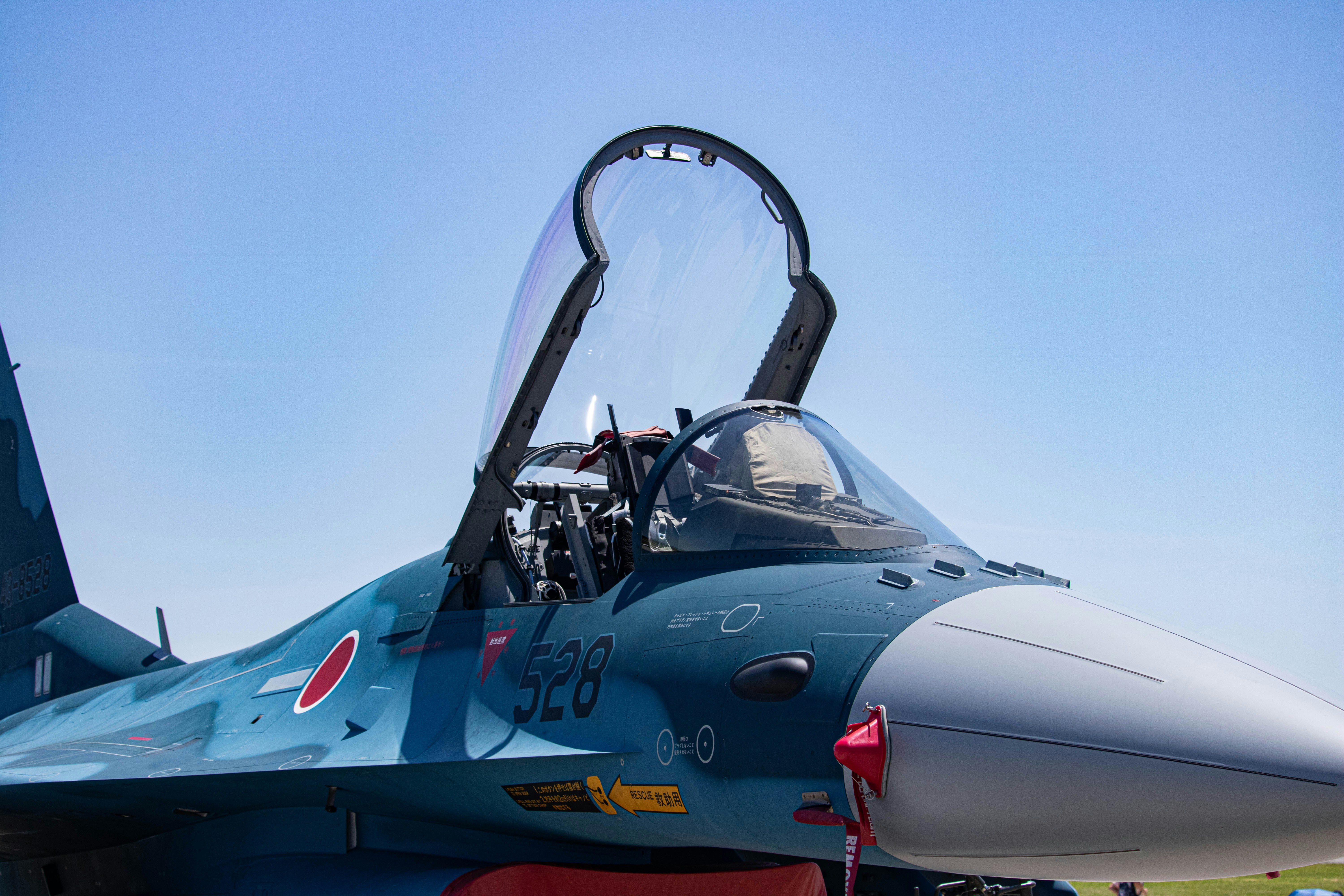 a fighter jet sitting on top of an airport tarmac