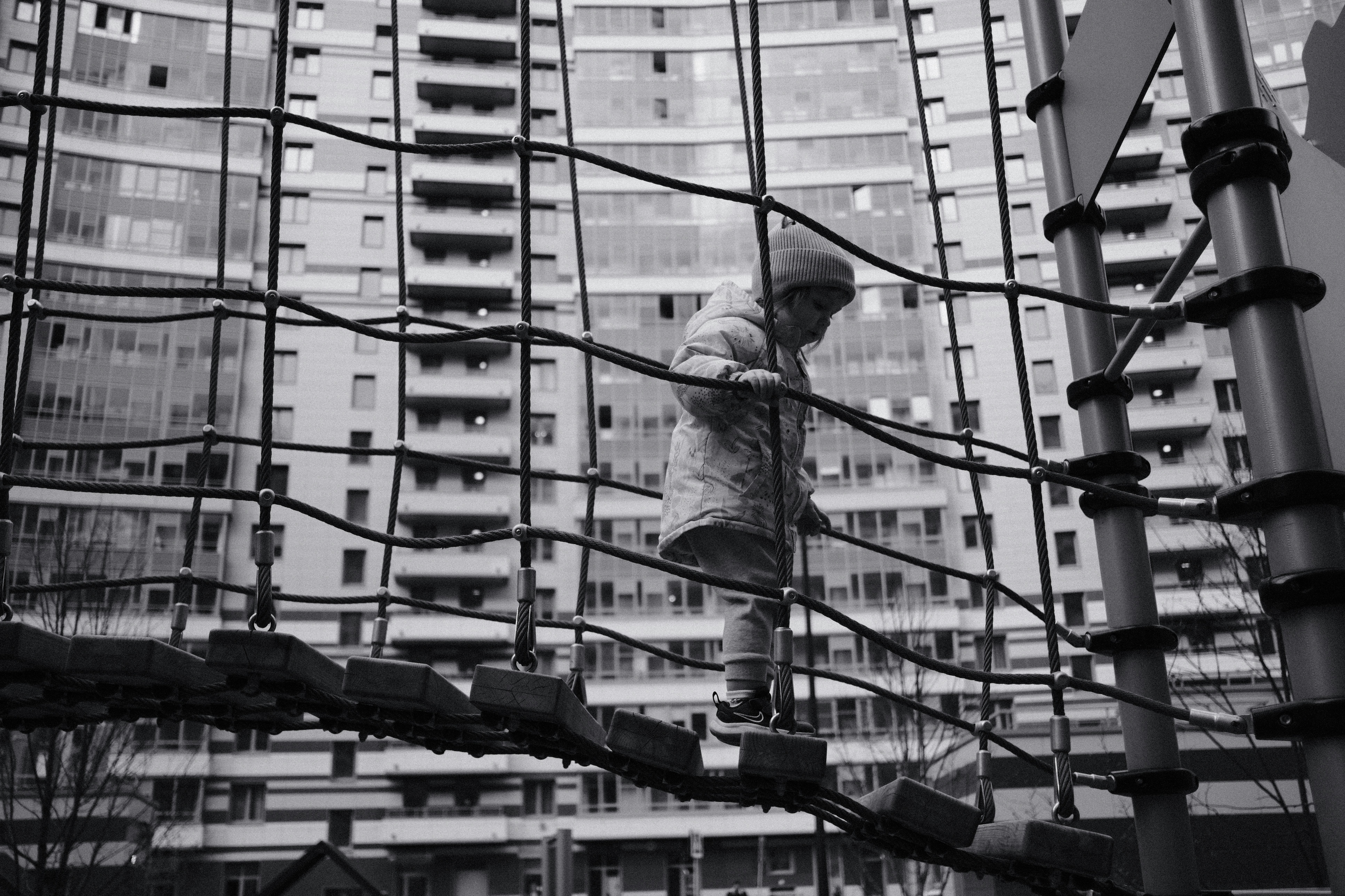 a man walking up a set of stairs next to a tall building