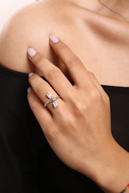 a woman's hand with a diamond ring on it