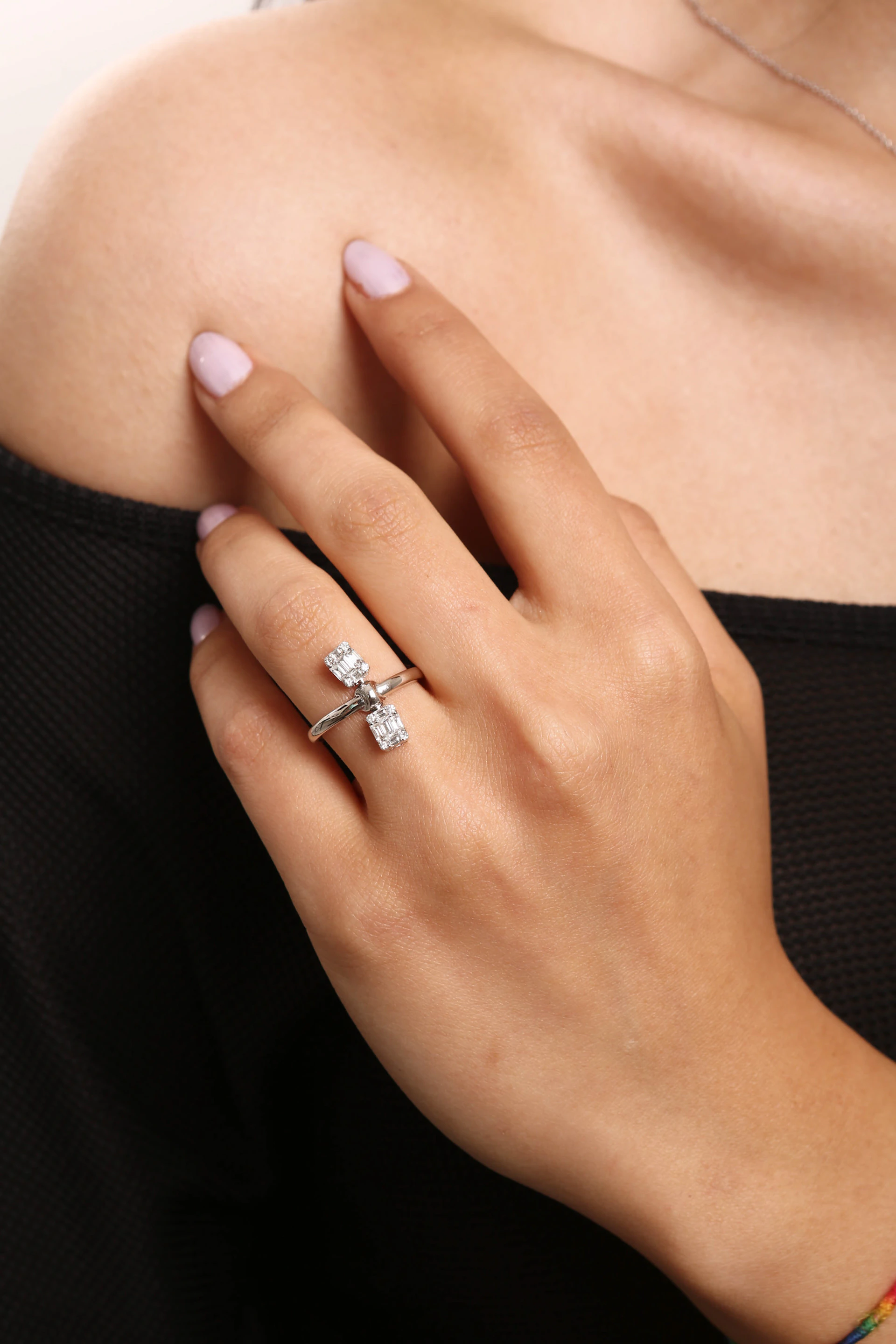 a woman's hand with a diamond ring on it