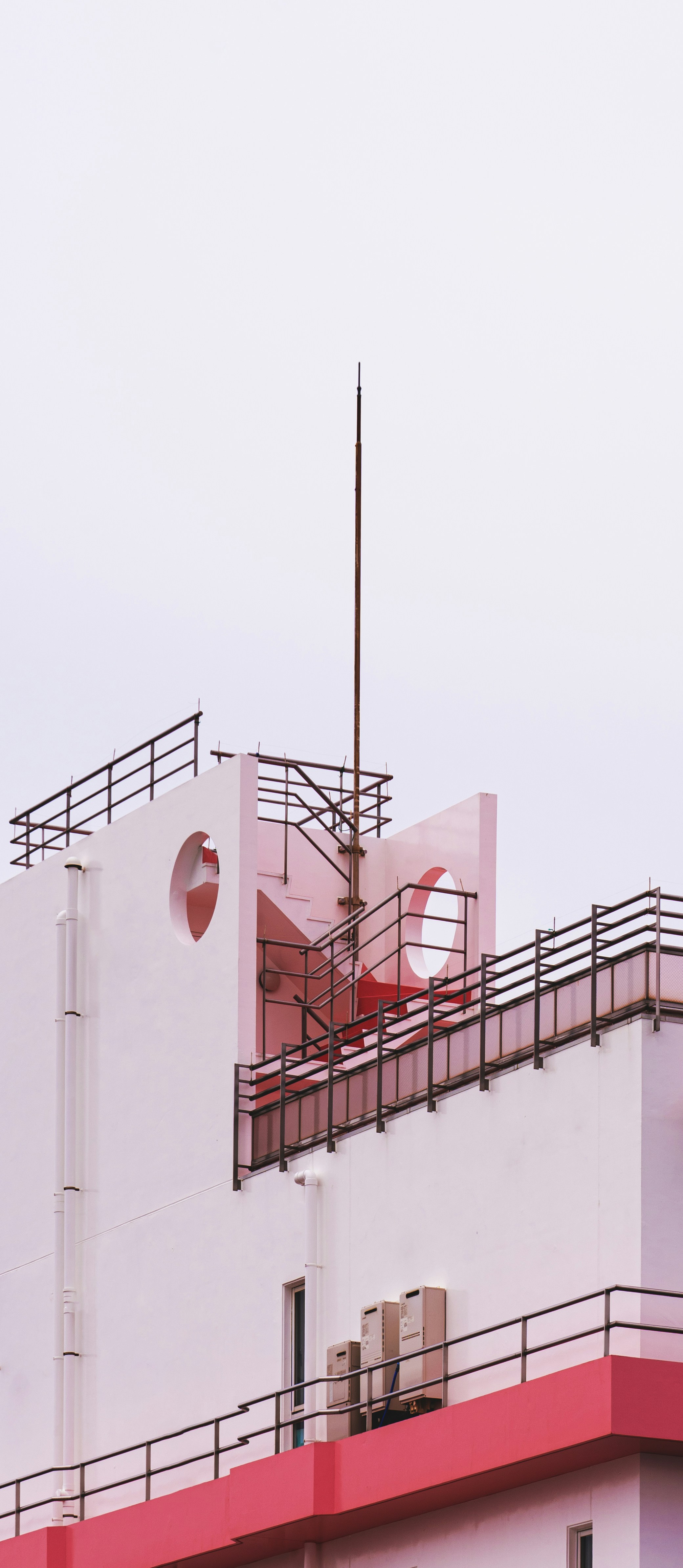 a red and white building with a clock on it