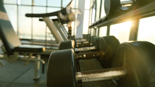 a row of exercise equipment in a gym
