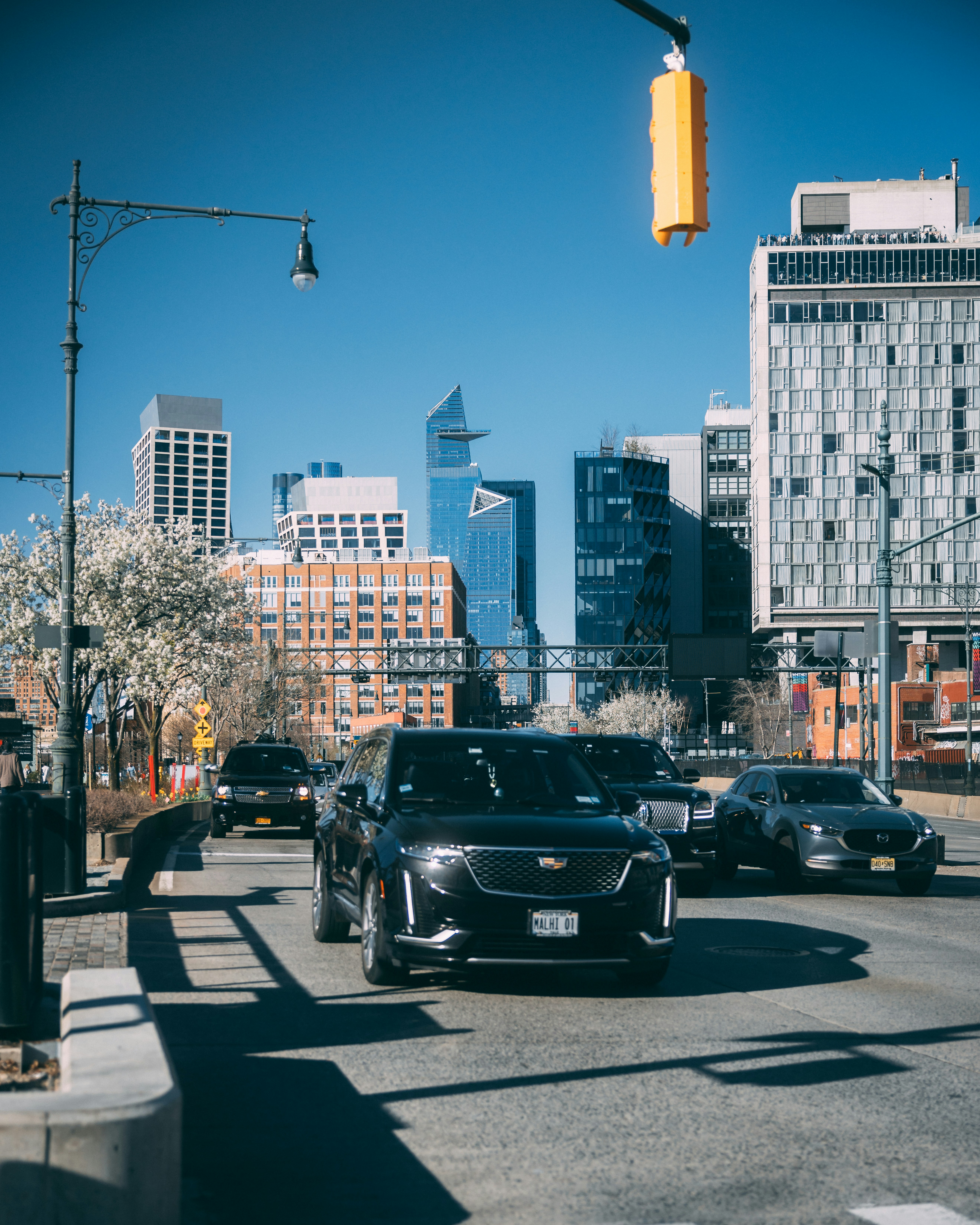 A city street filled with lots of traffic next to tall buildings photo ...