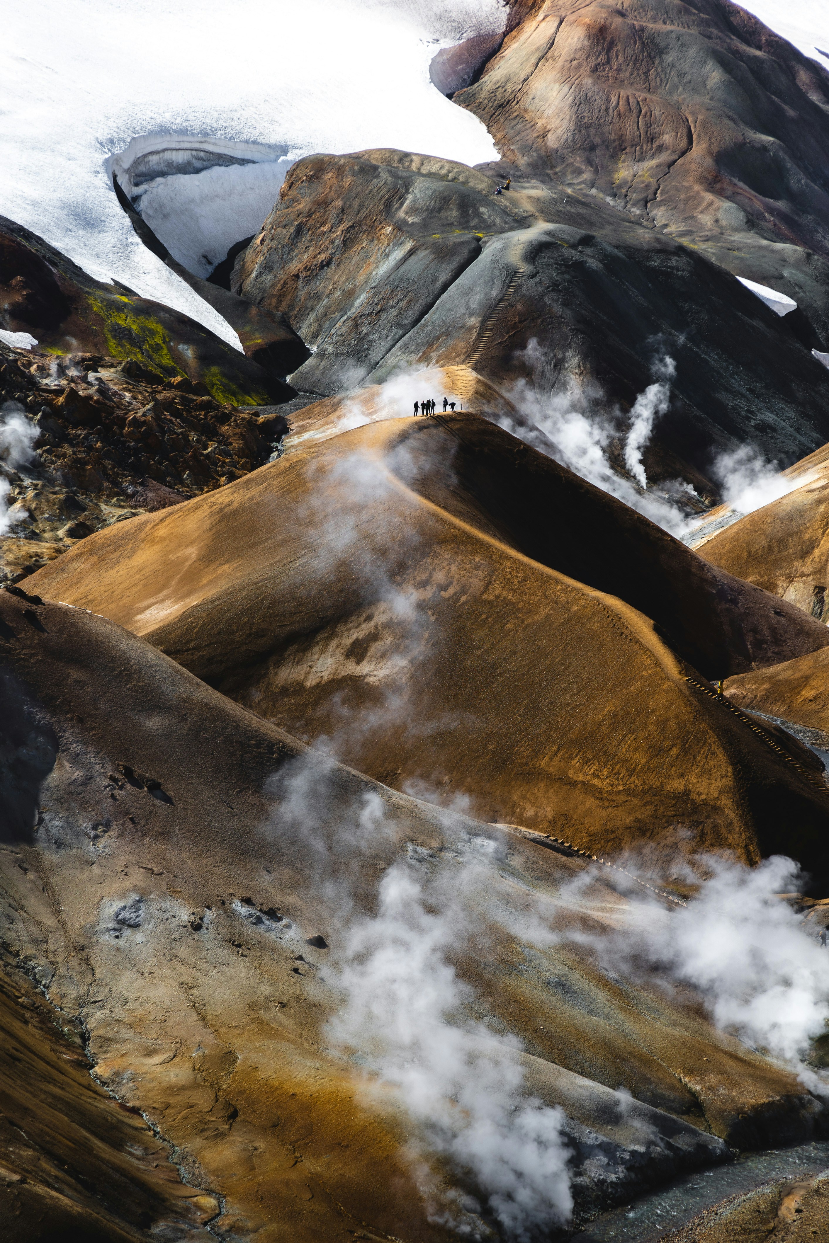 a group of people standing on top of a mountain