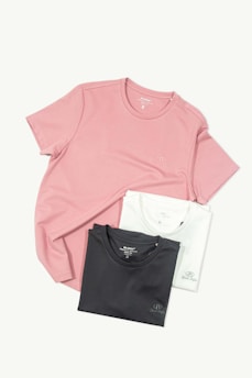 three t - shirts sitting on top of each other