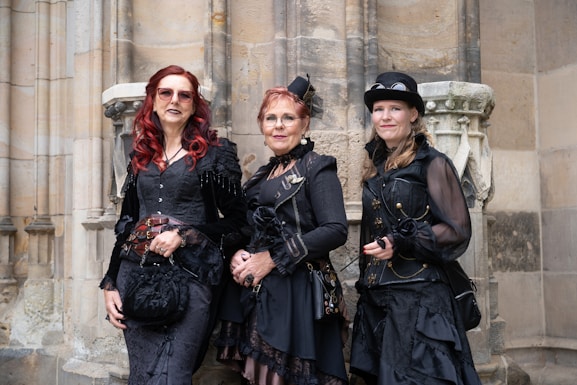 a group of three women standing next to each other
