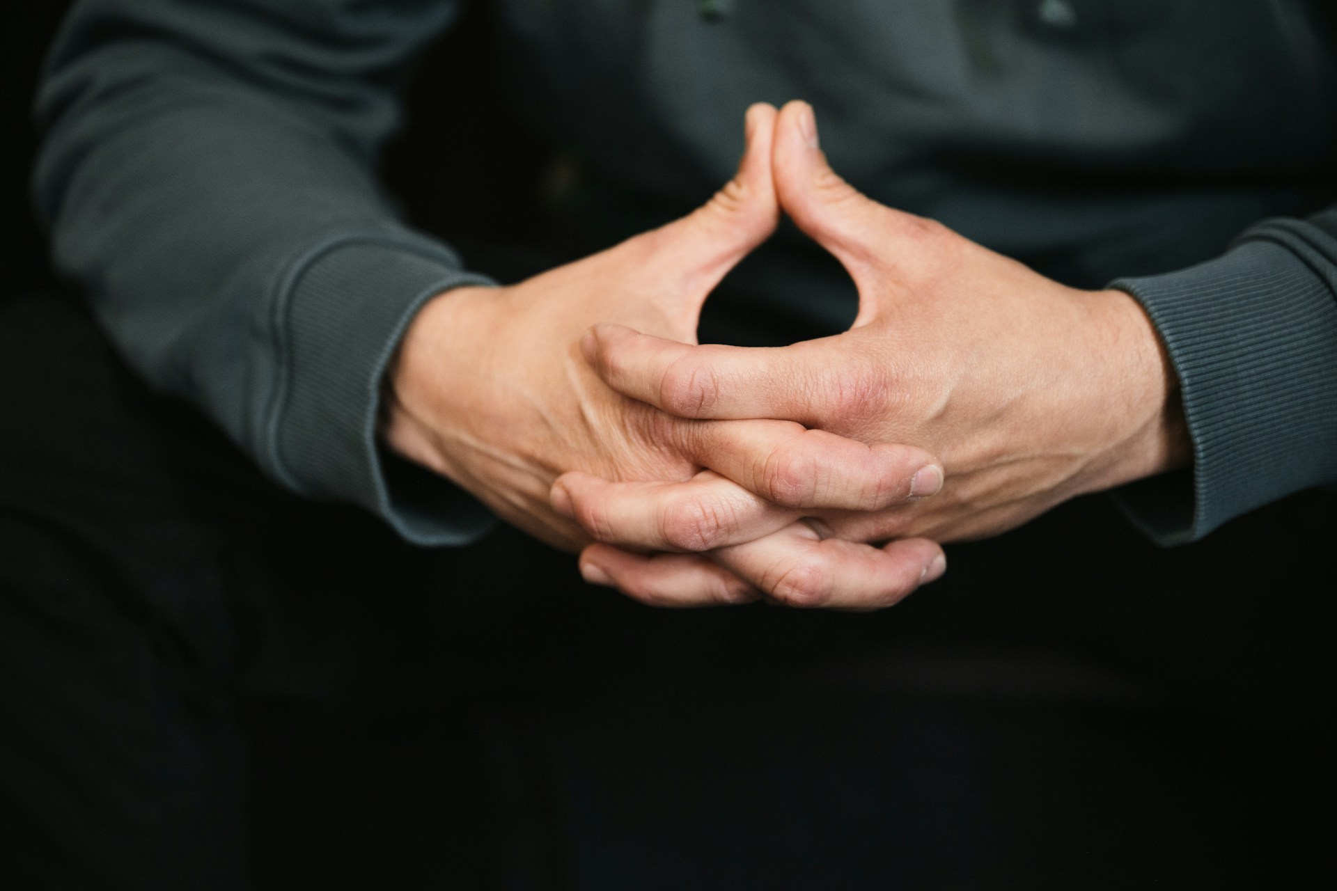 a person is holding their hands together