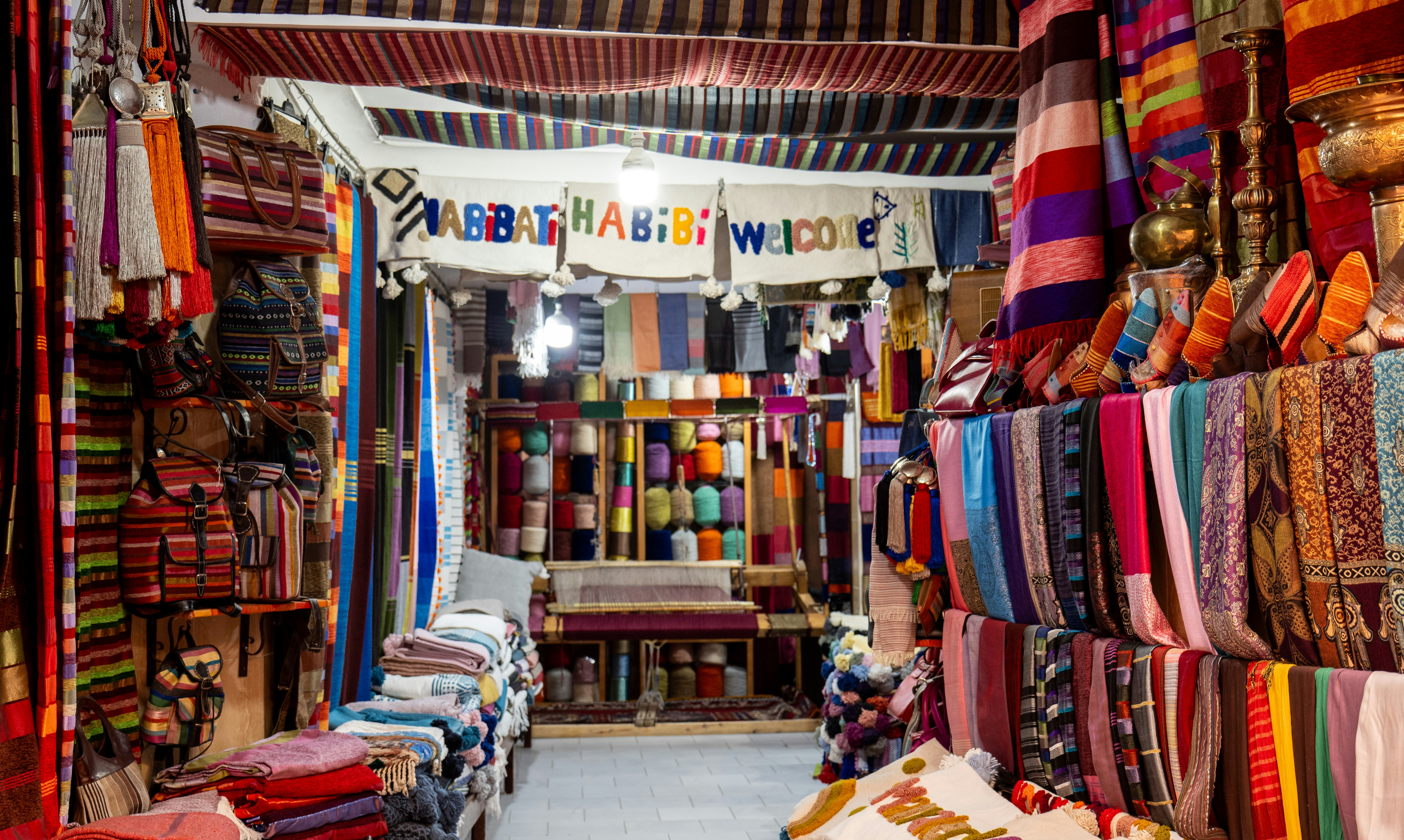a store filled with lots of colorful fabrics