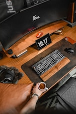 a person sitting at a desk with a keyboard and mouse