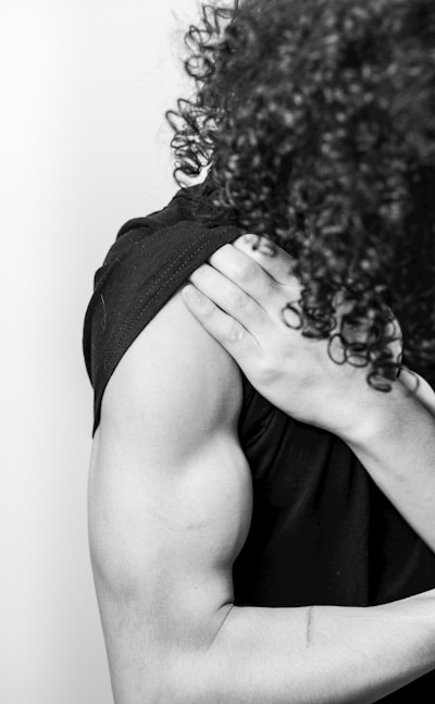 a black and white photo of a woman with curly hair