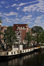 a boat is parked on the side of a river
