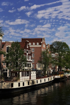 a boat is parked on the side of a river