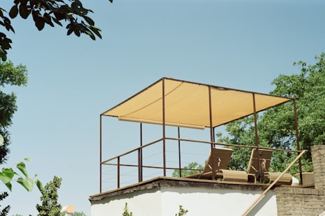a balcony with a chair and a canopy on top of it