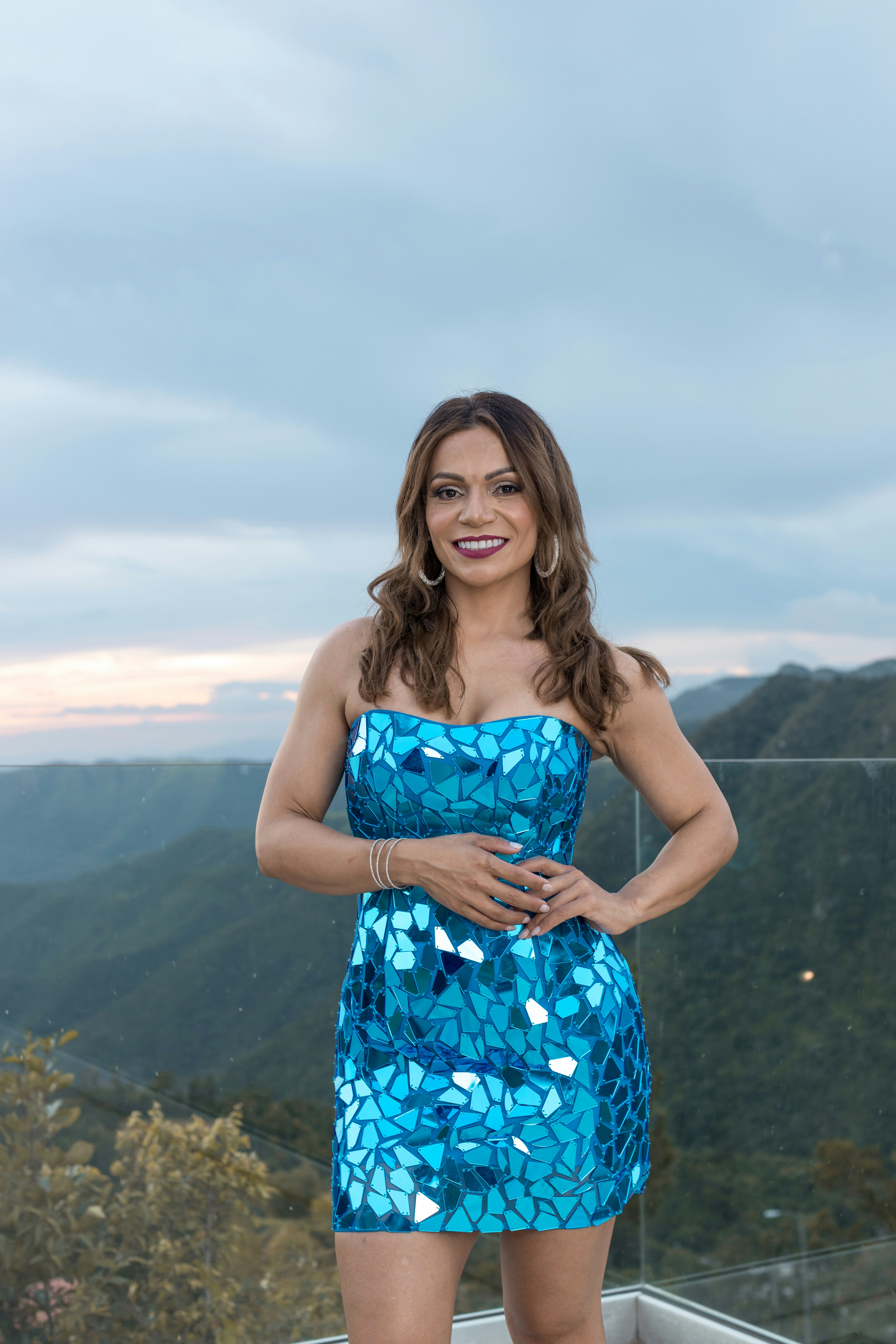 a woman in a blue dress posing for a picture