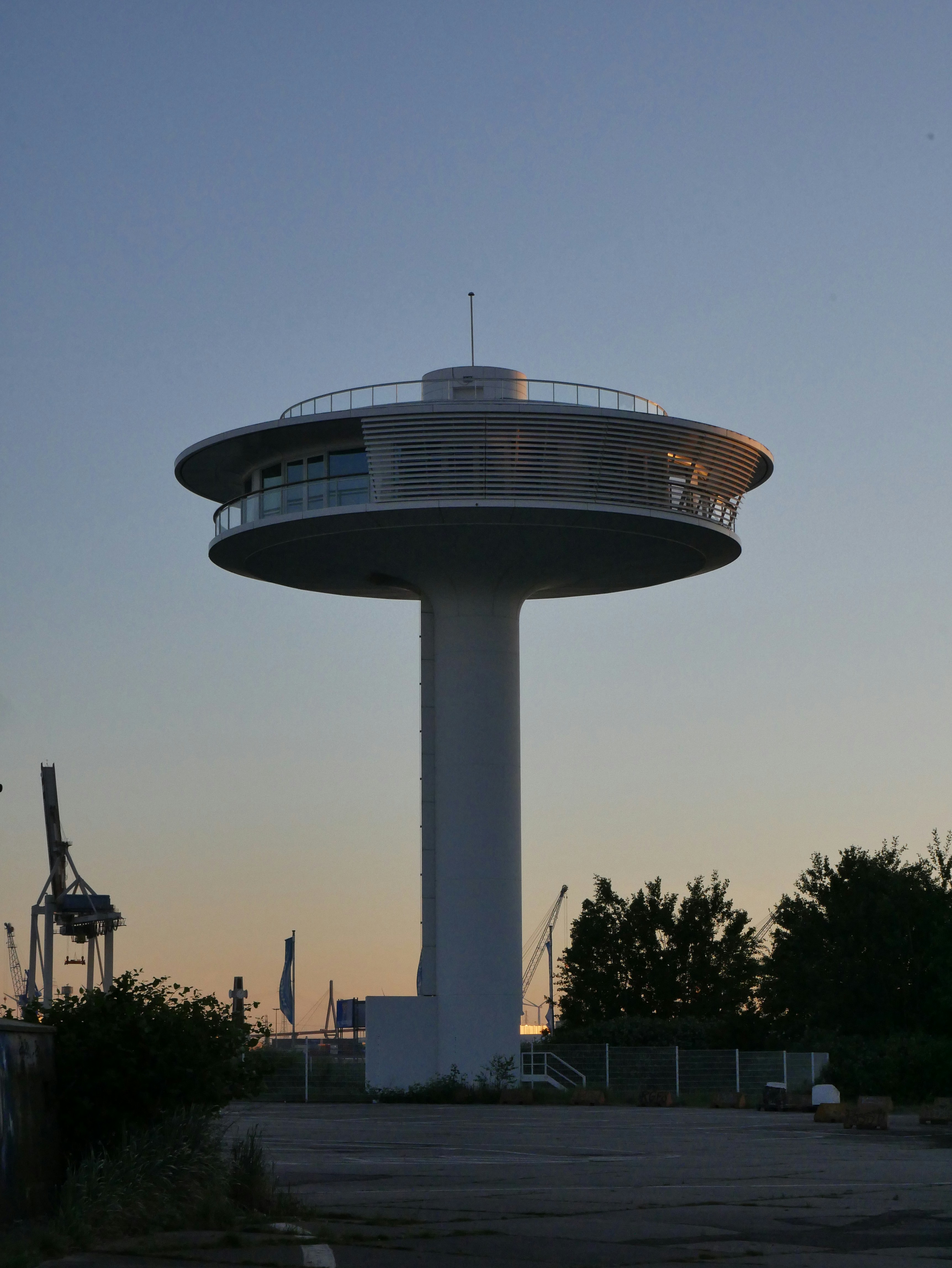 a tall white tower with a clock on top of it