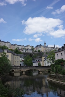 a river running through a small town next to a bridge
