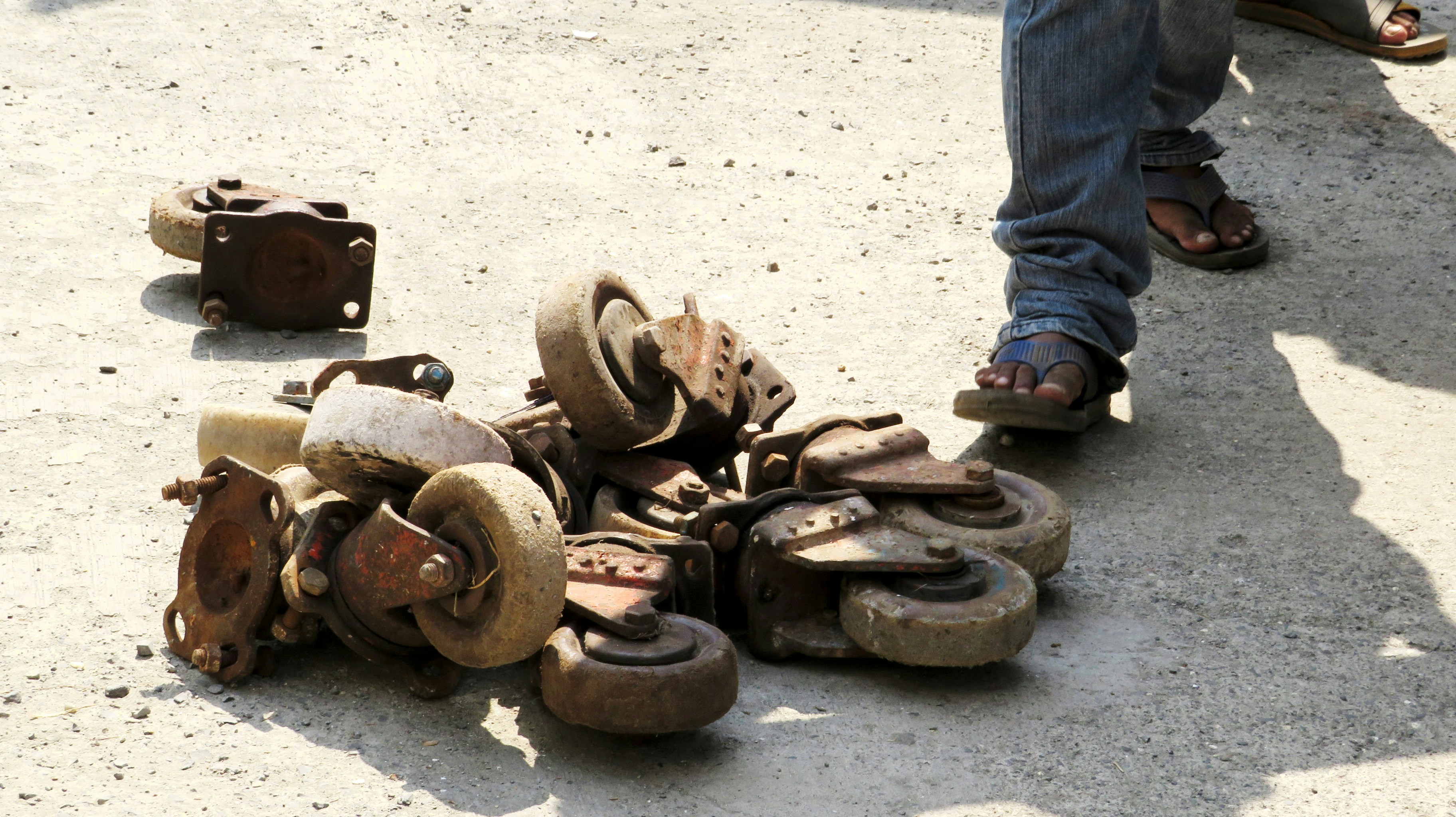 a pile of old shoes sitting on the ground