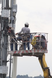 a couple of men standing on top of a lift