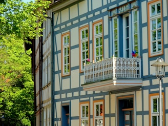 a blue and white building with windows and a balcony
