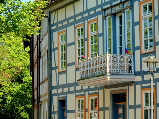 a blue and white building with windows and a balcony