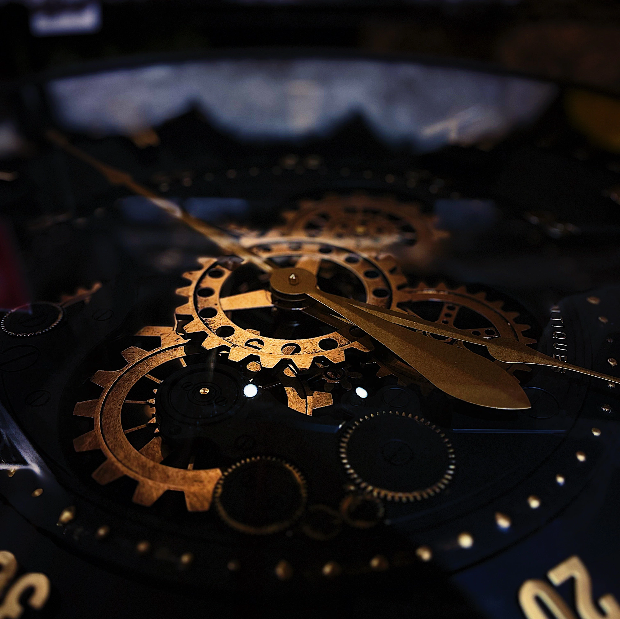 Macro close-up of brass mechanical clock gears on a dark background