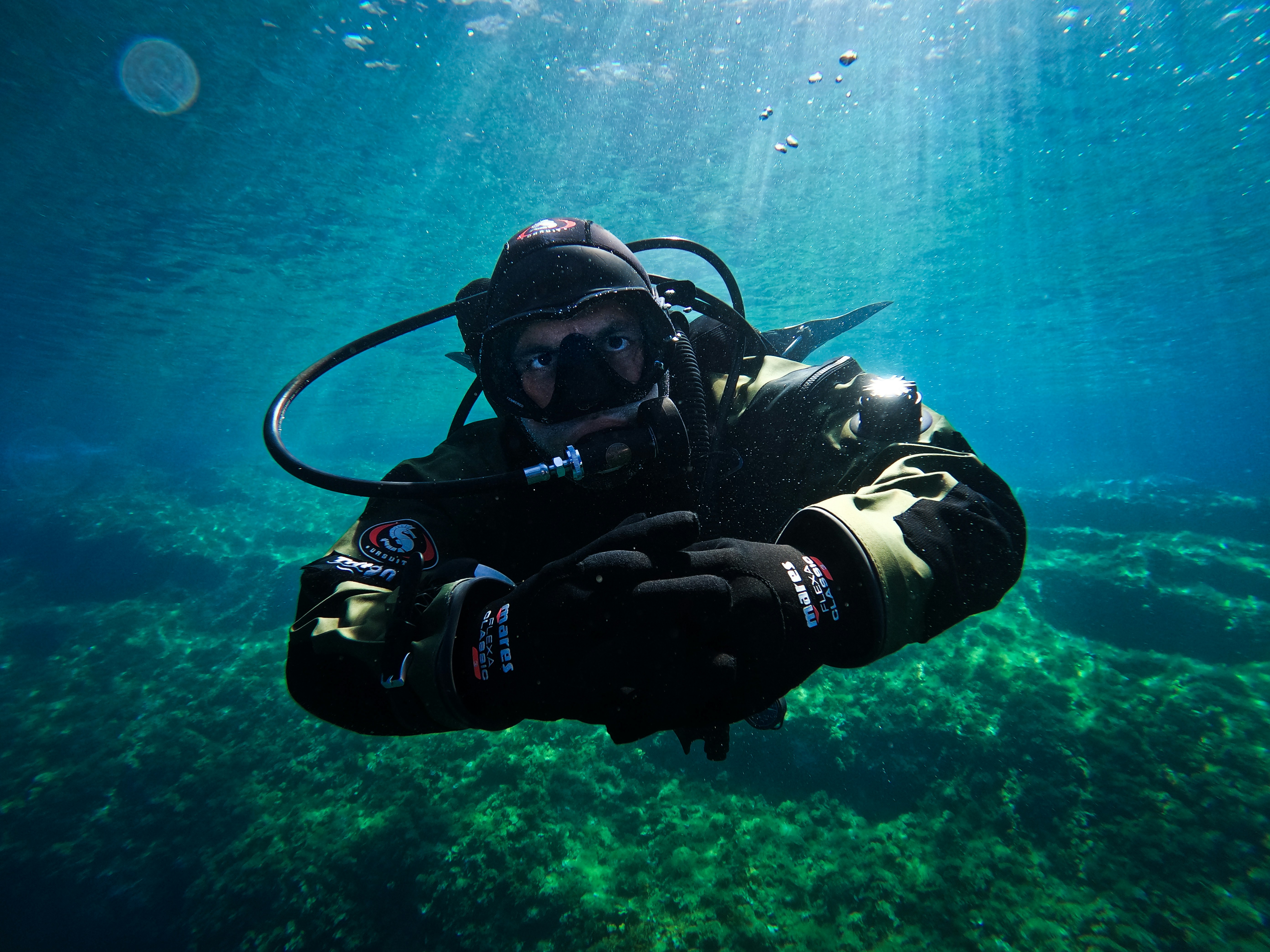 a man in a diving suit is under water