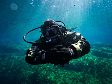 a man in a diving suit is under water