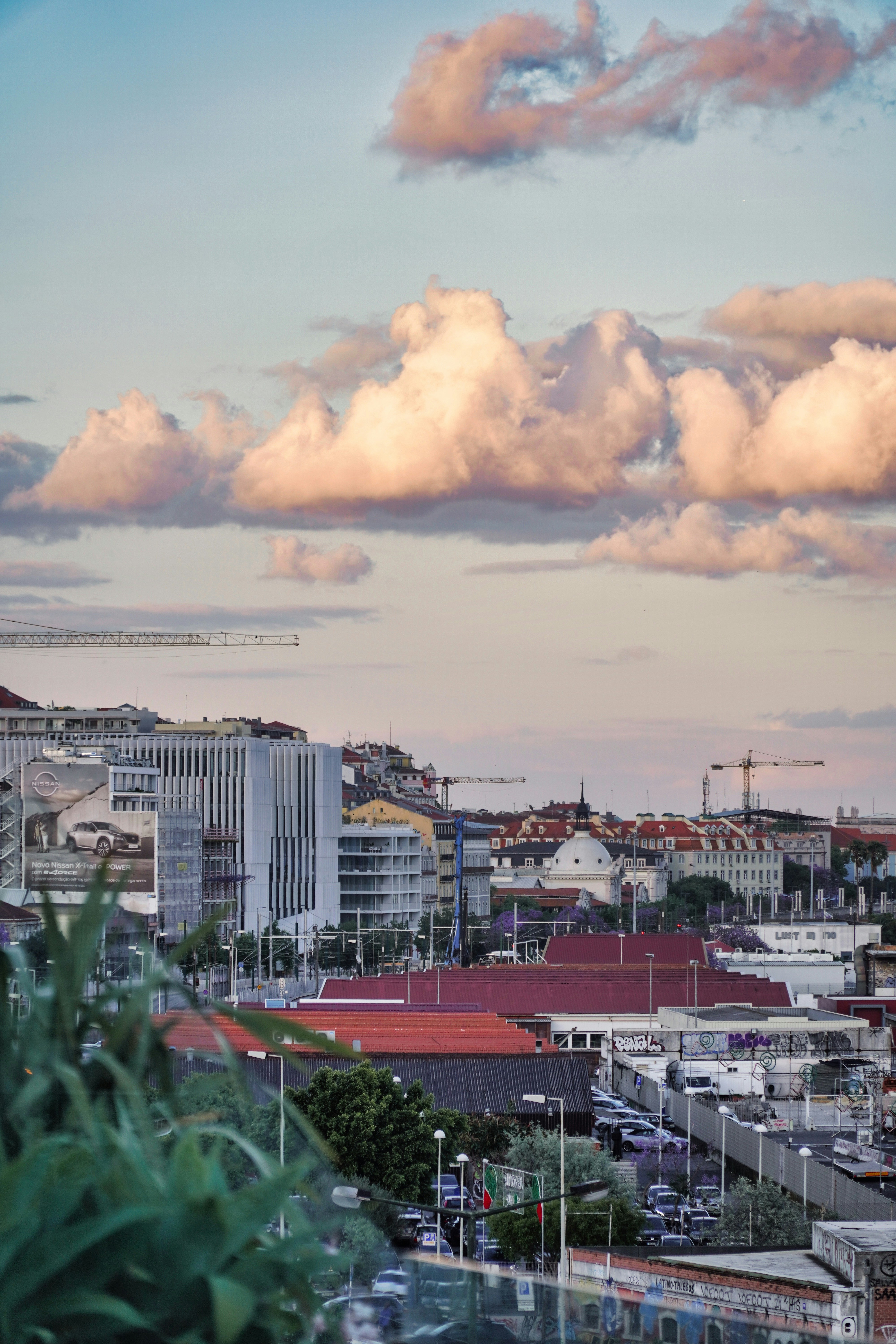 a city with a lot of tall buildings under a cloudy sky