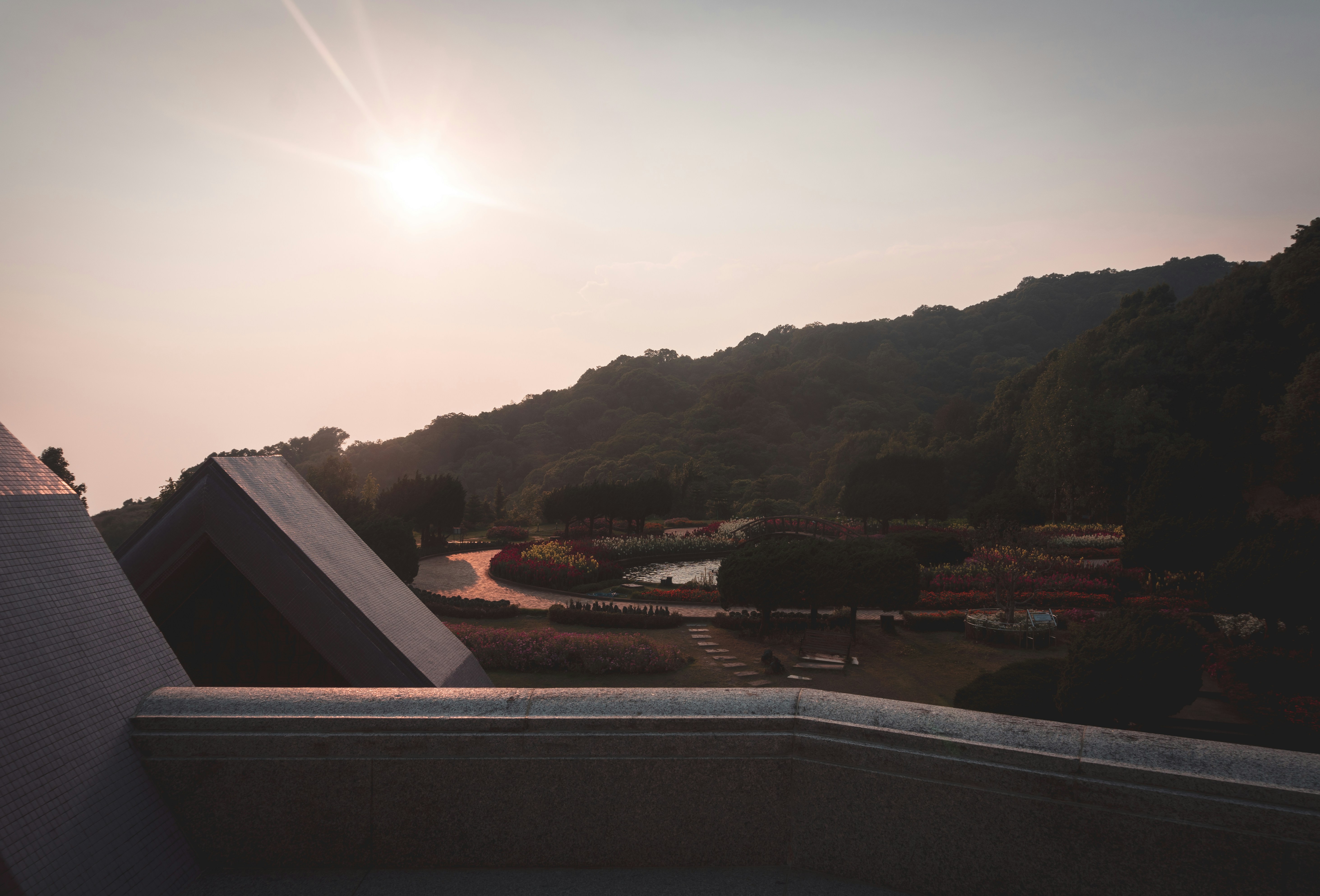 the sun is setting over a building with a steeple