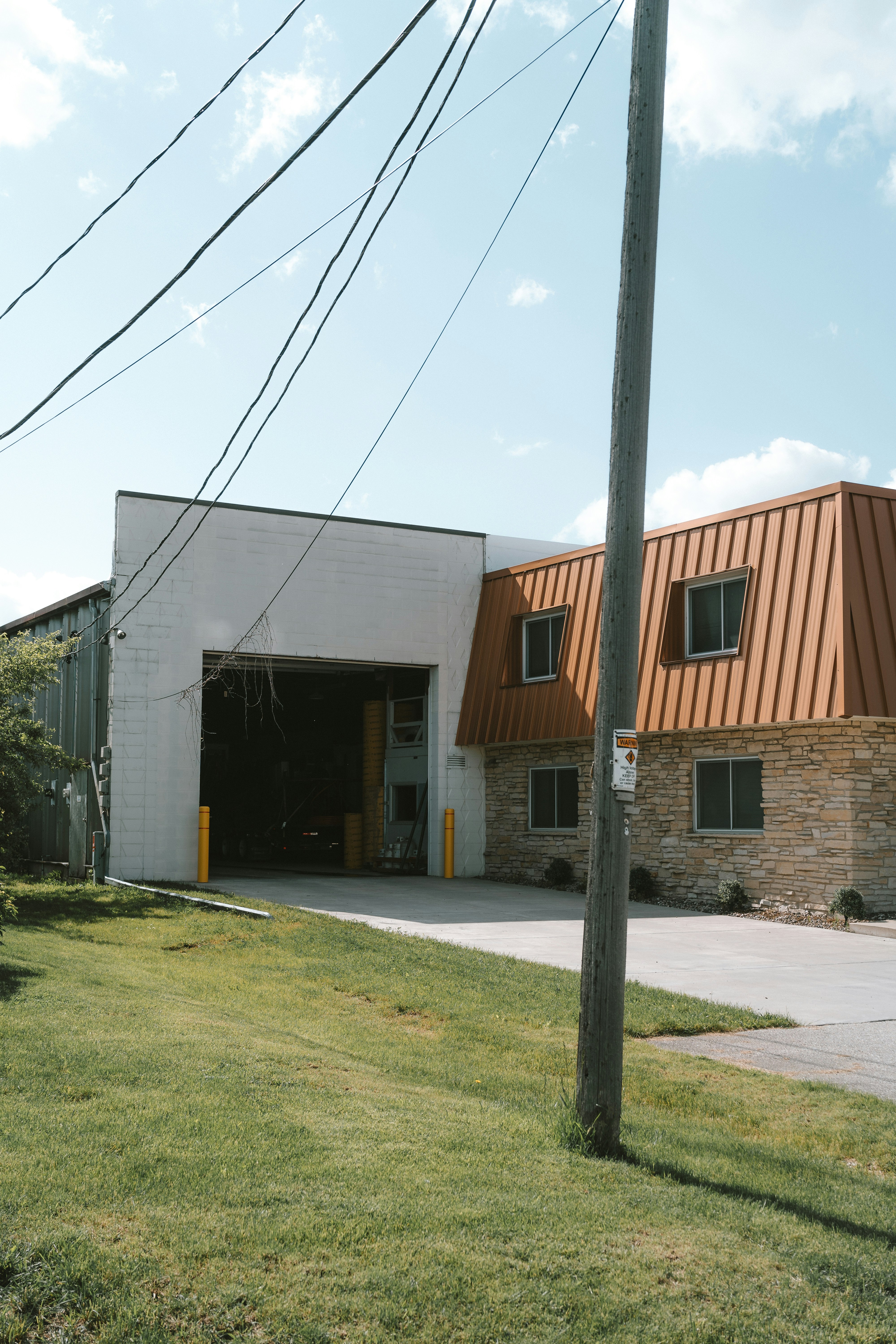 a building with a metal roof next to a street