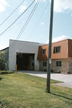 a building with a metal roof next to a street