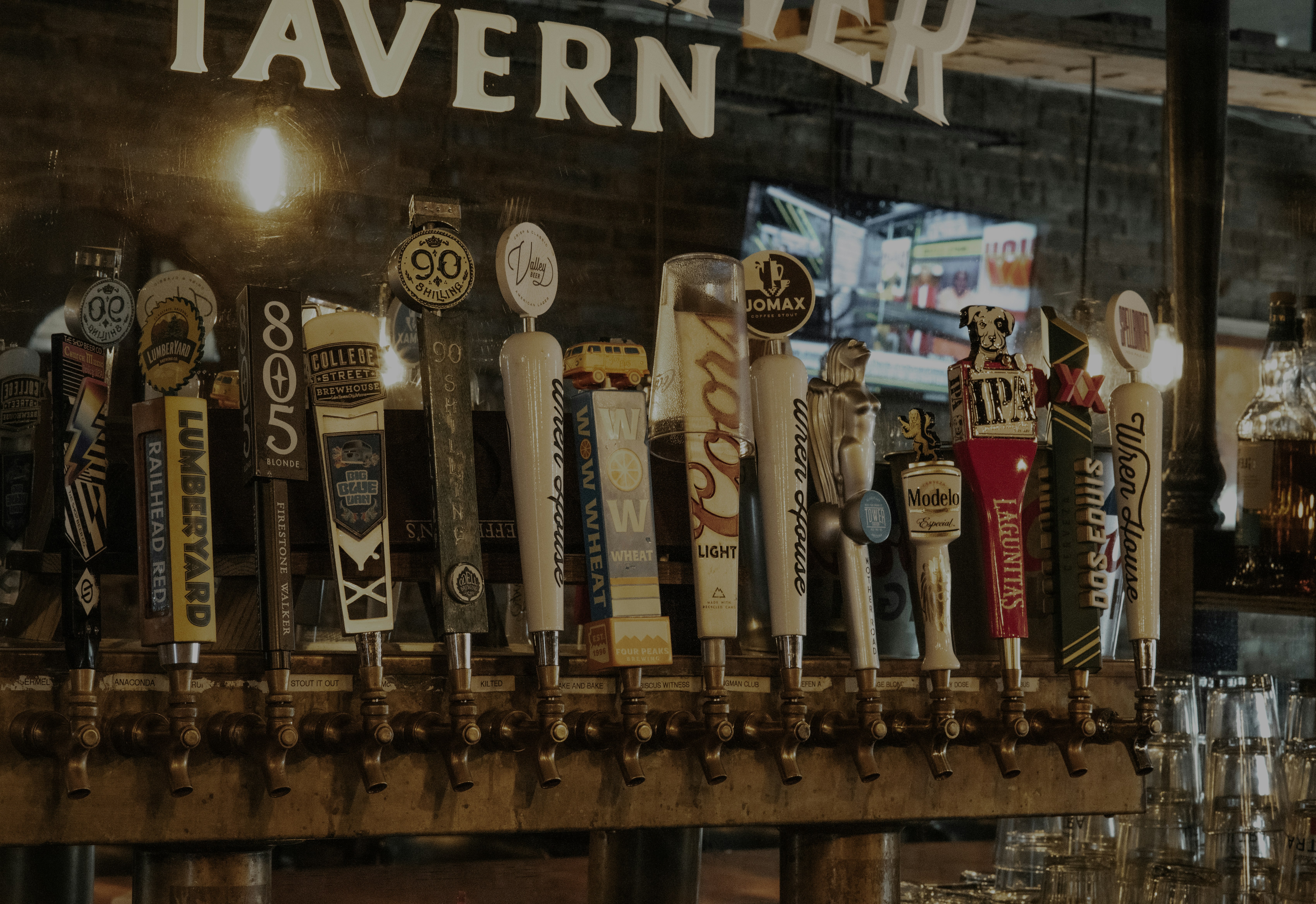 a bunch of beer taps lined up on a bar