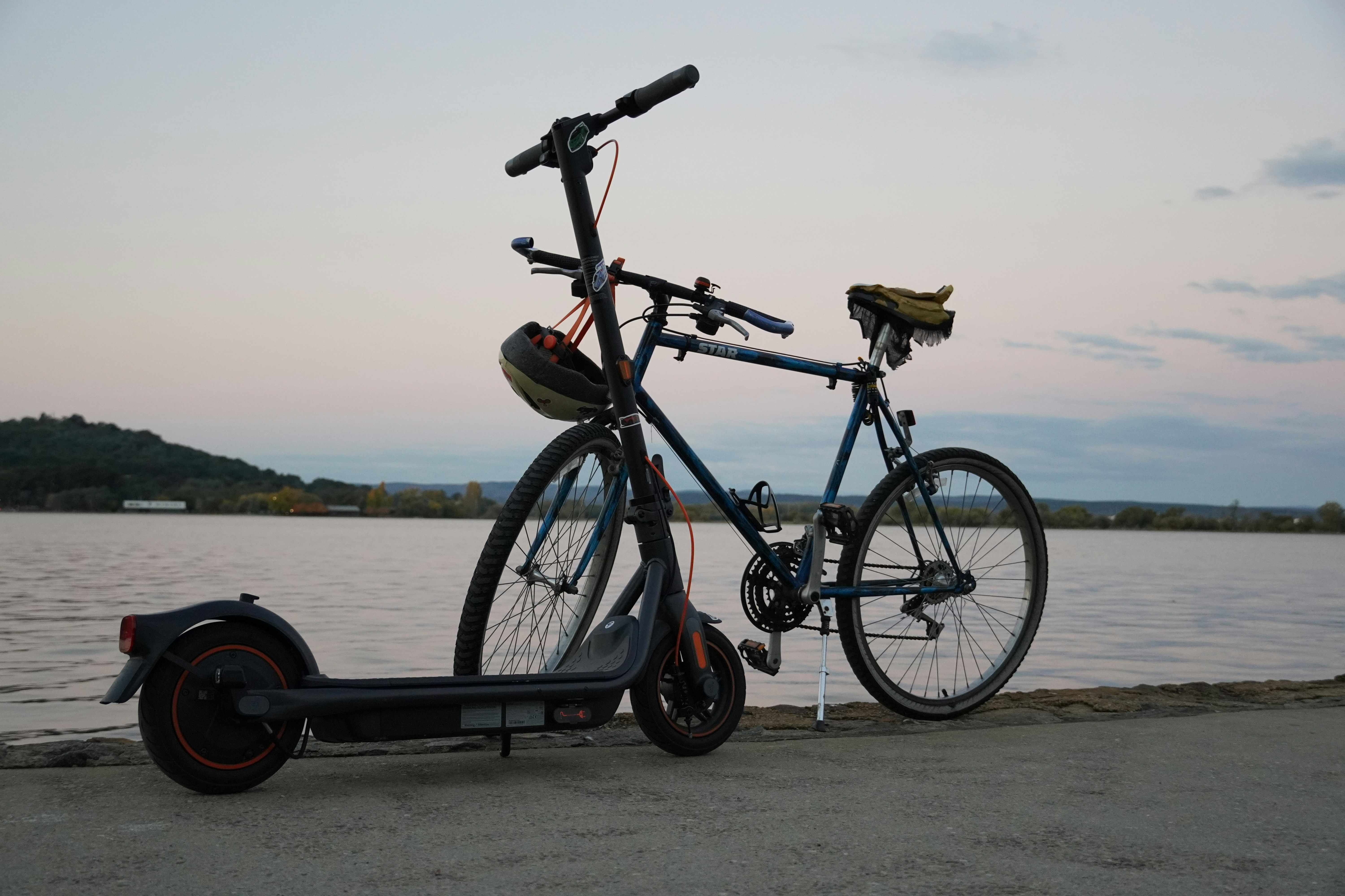 a scooter parked next to a body of water
