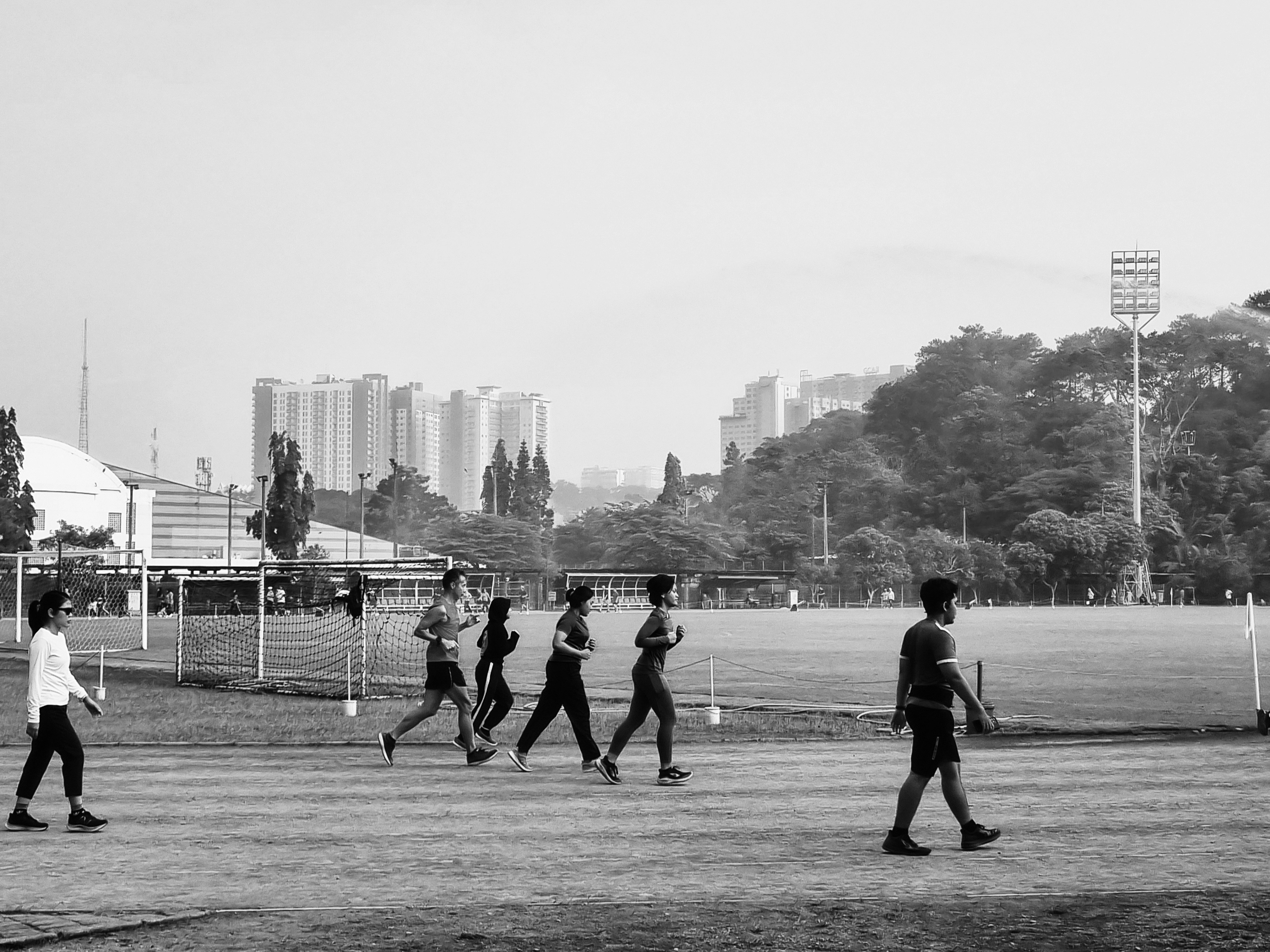 Track athlete running at athletic event in black and white dramatic style