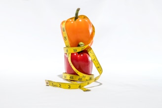 a measuring tape wrapped around a bell pepper