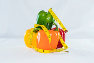 a measuring tape wrapped around peppers and peppers