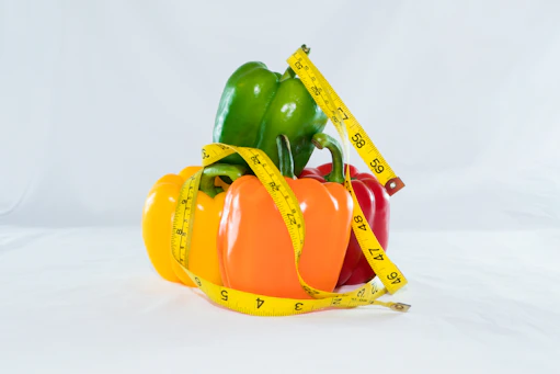 a measuring tape wrapped around peppers and peppers