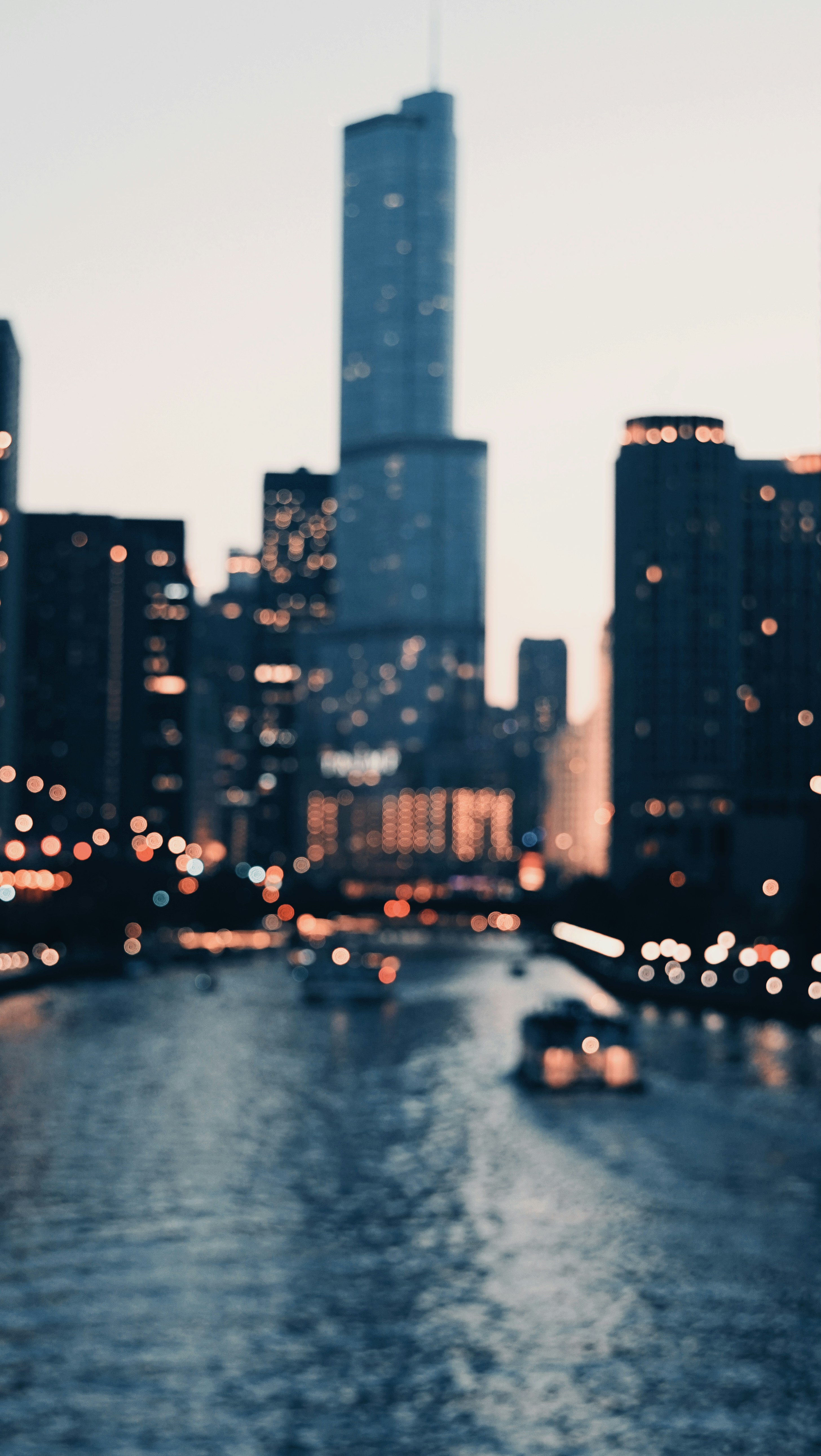 a boat traveling down a river next to tall buildings