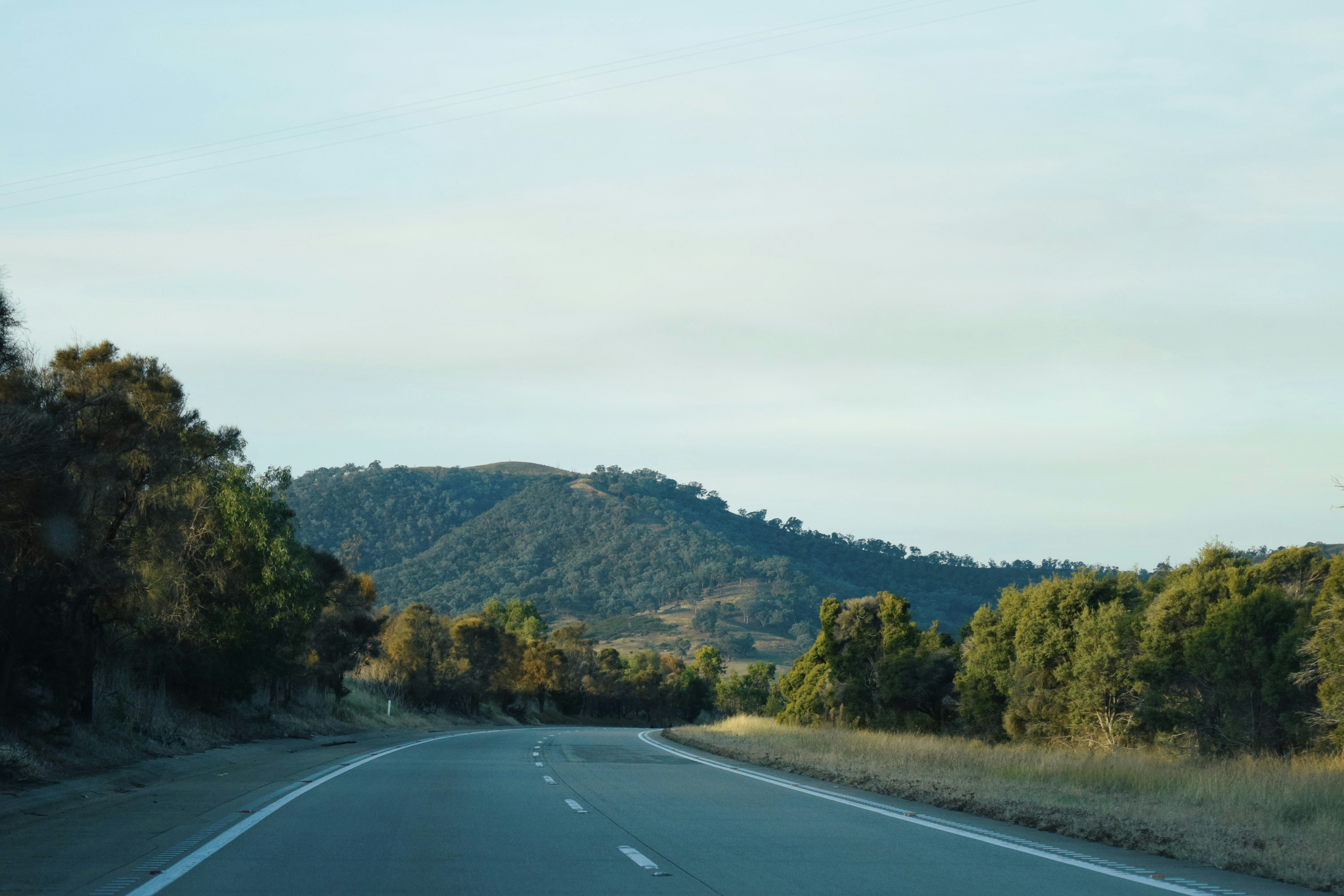 a view of a road with a mountain in the background